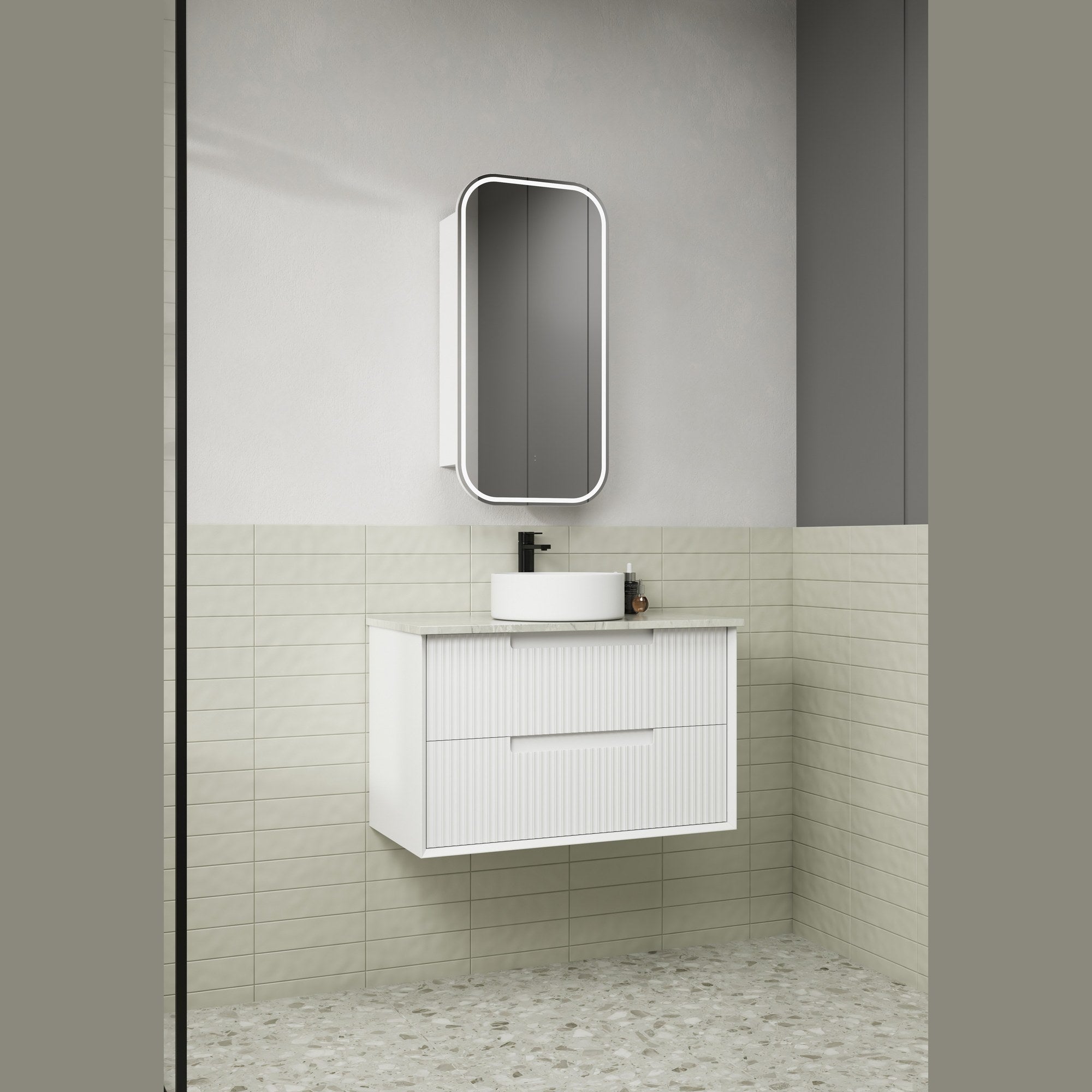 Aulic white wall hung vanity with fluted drawer fronts and stone-look top in a bathroom setting