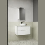 Aulic white wall hung vanity with fluted drawer fronts and stone-look top in a bathroom setting