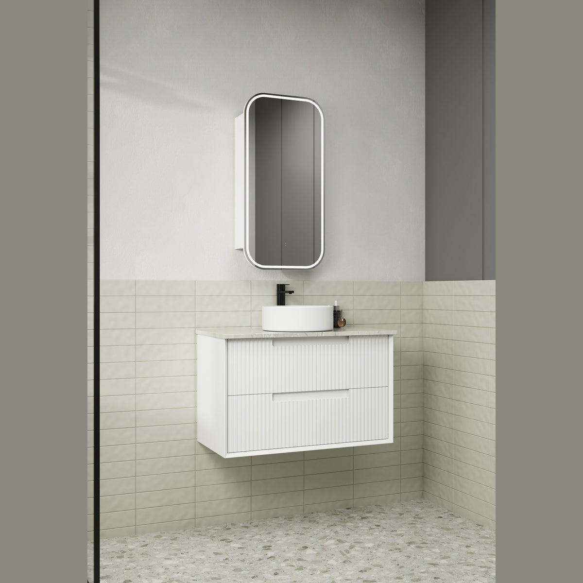 Aulic white wall hung vanity with fluted drawer fronts and stone-look top in a bathroom setting
