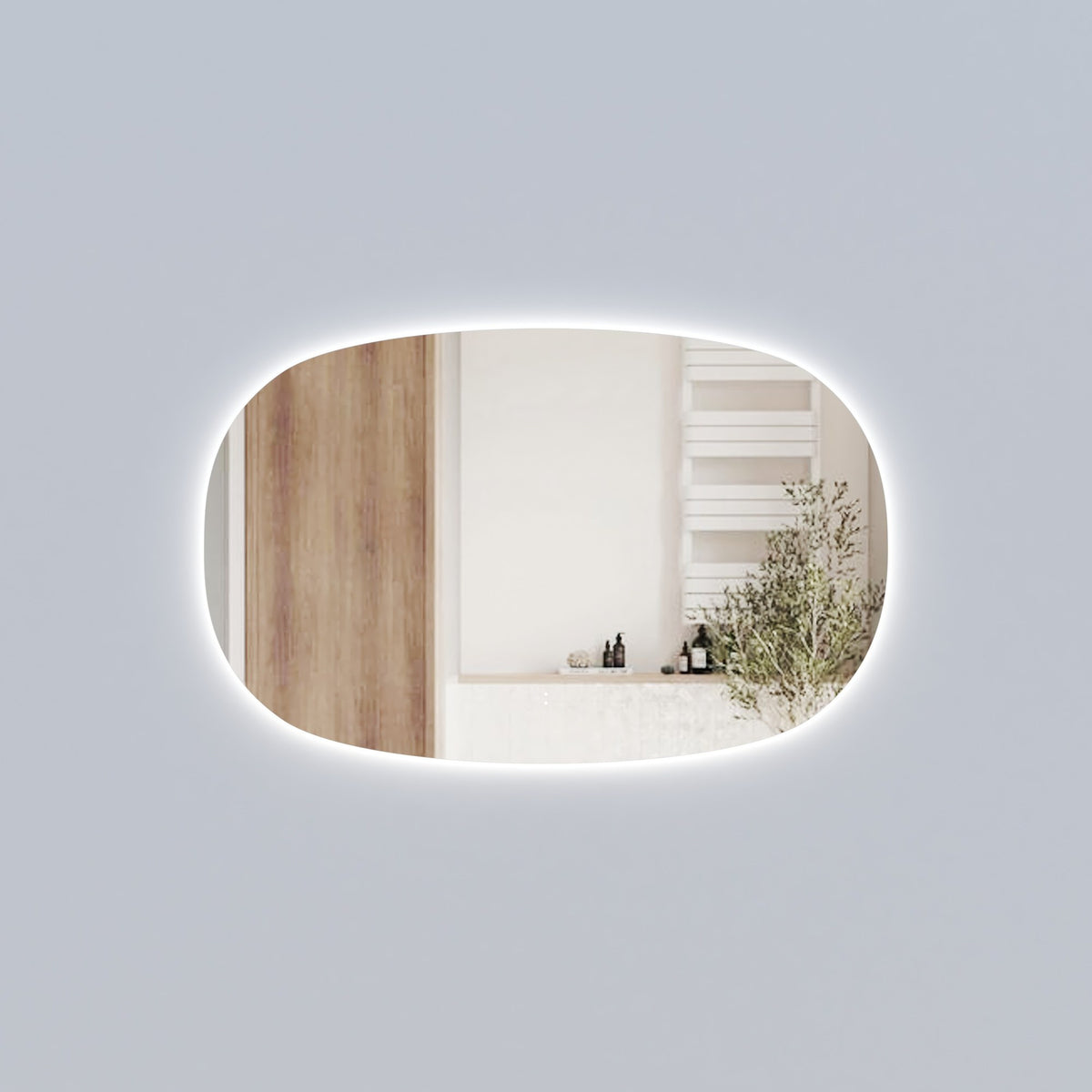 Aulic Valmont horizontal LED mirror with soft rounded rectangle shape and backlit glow in a bathroom setting