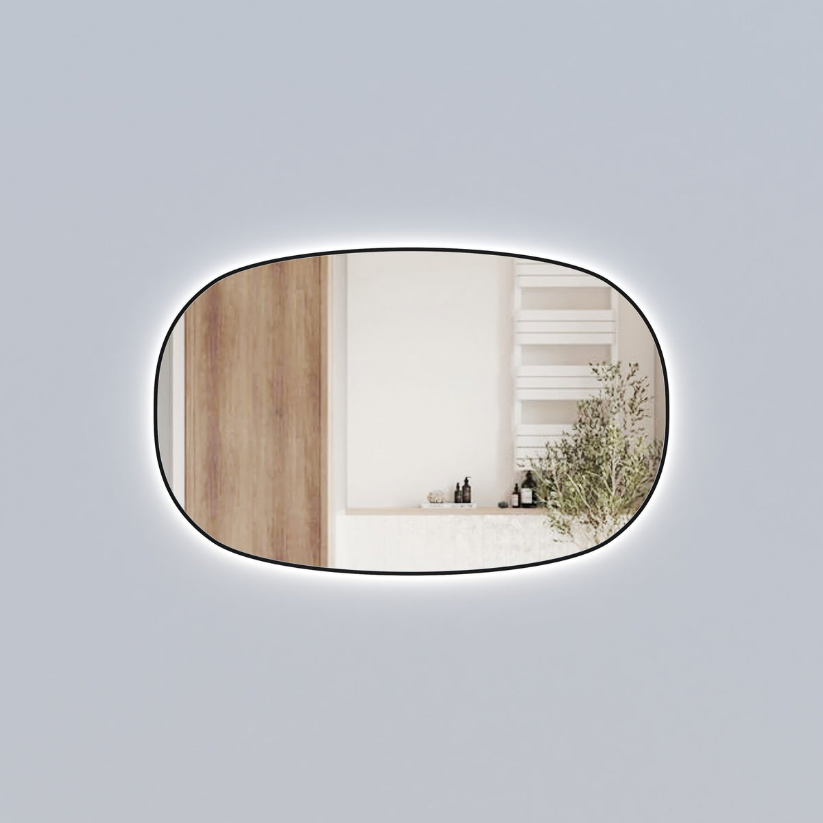 Aulic Valmont horizontal LED mirror with black frame and rounded rectangle shape, lit against a grey wall