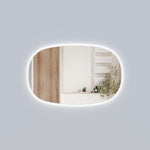 Aulic Valmont horizontal LED mirror with soft rounded edges and backlit glow, shown on a light grey wall with reflection