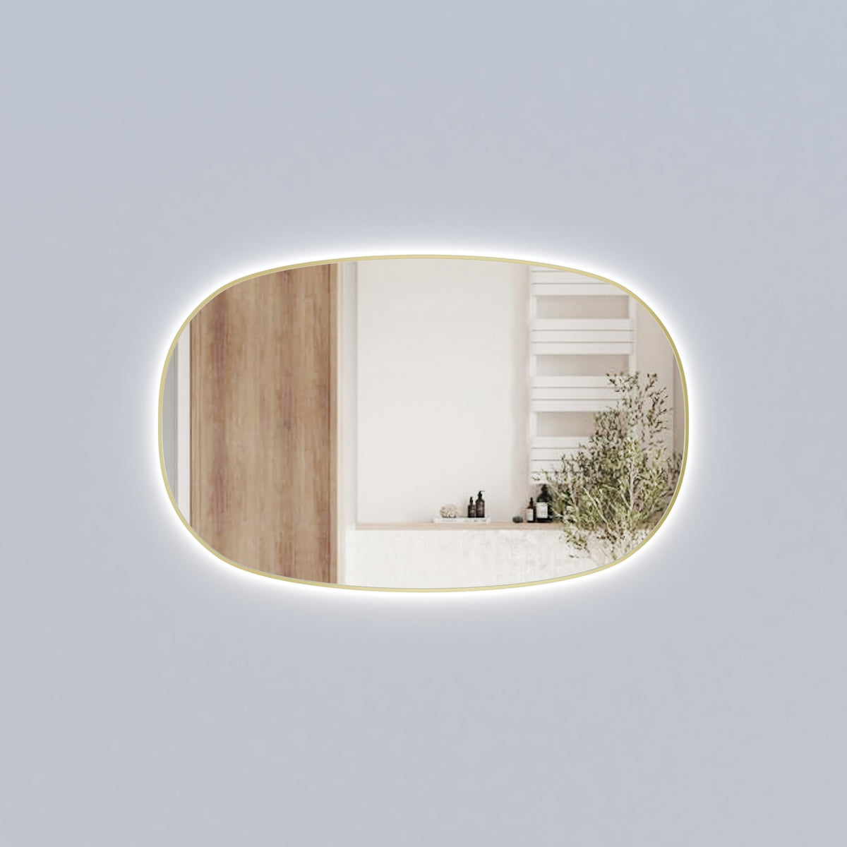 Aulic Valmont horizontal LED mirror in brushed bronze, with rounded rectangle shape and backlit glow