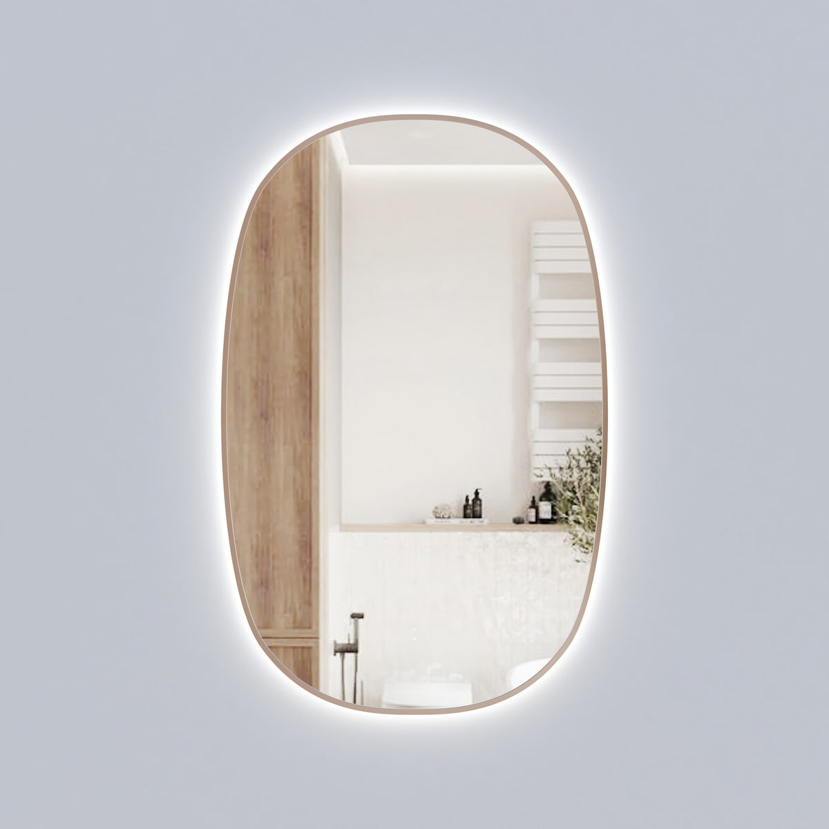 Aulic Valmont vertical LED mirror with soft rounded corners and warm brushed gold frame, wall-mounted in bathroom setting