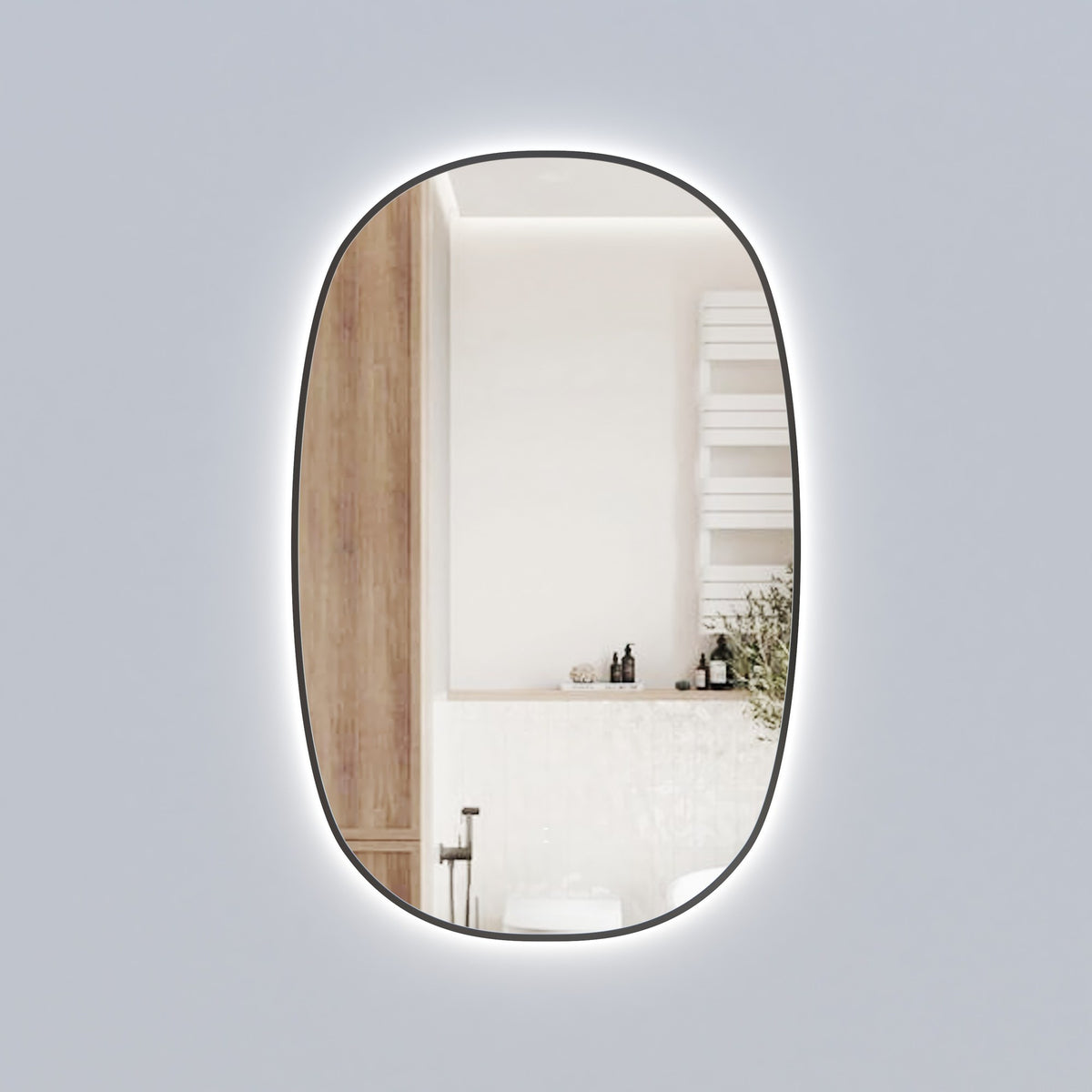 Aulic Valmont vertical LED mirror with black frame, tall rounded rectangle wall mirror with backlit glow, in bathroom setting