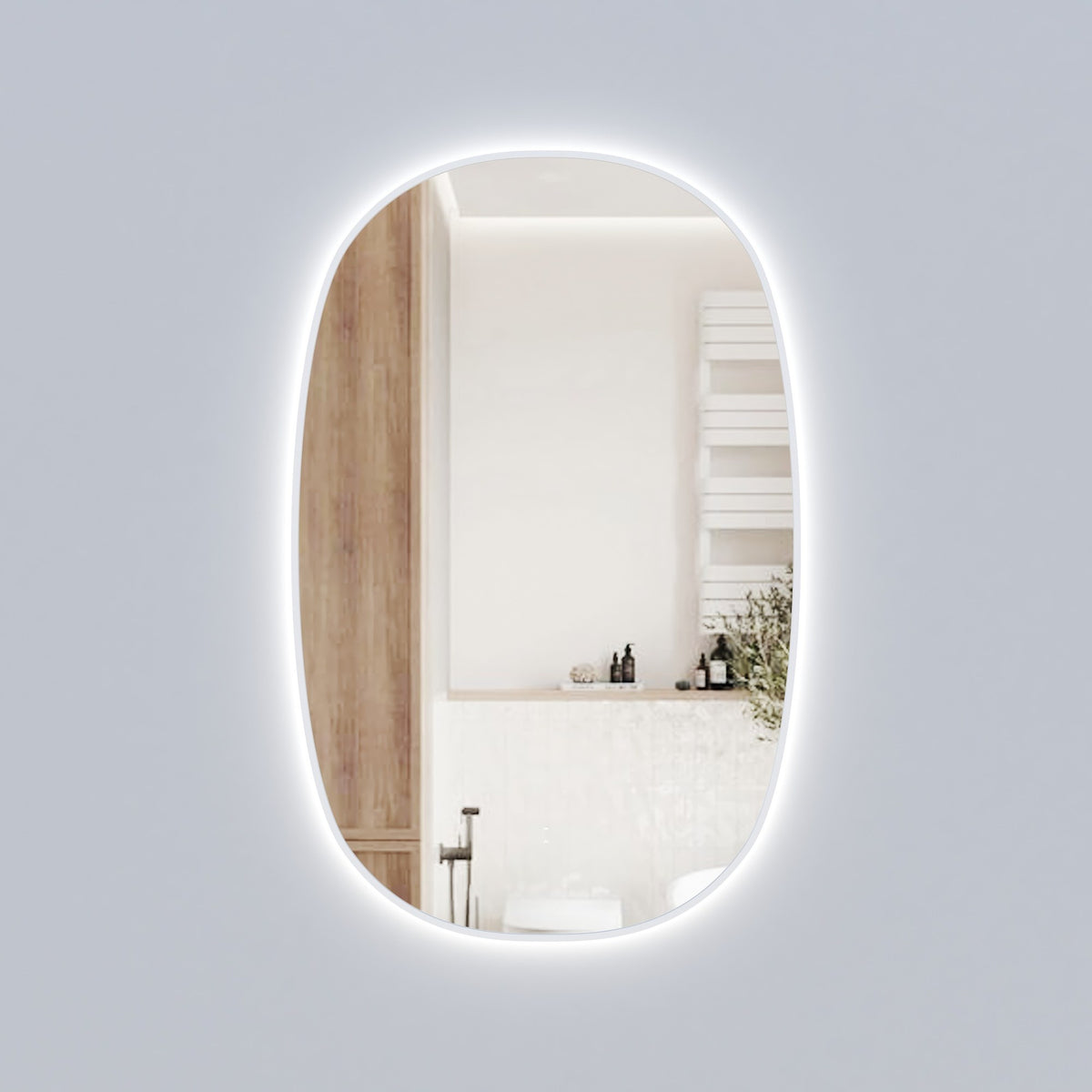 Aulic Valmont vertical LED mirror, tall rounded-rectangle design with front and backlit glow in a bathroom setting