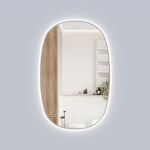 Aulic Valmont vertical LED mirror with rounded rectangle shape and gun metal frame, lit against a pale wall