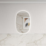 Aulic Valmont frameless vertical LED mirror with rounded-rectangle shape and backlit glow on a tiled wall