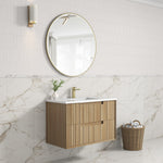 Aulic Voulari wall hung vanity in woodgrain with white top and drawer front, shown in a modern bathroom setting