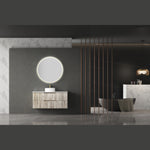 Aulic Windsor round LED mirror in matte white, lit above a wall-hung vanity in a modern bathroom setting