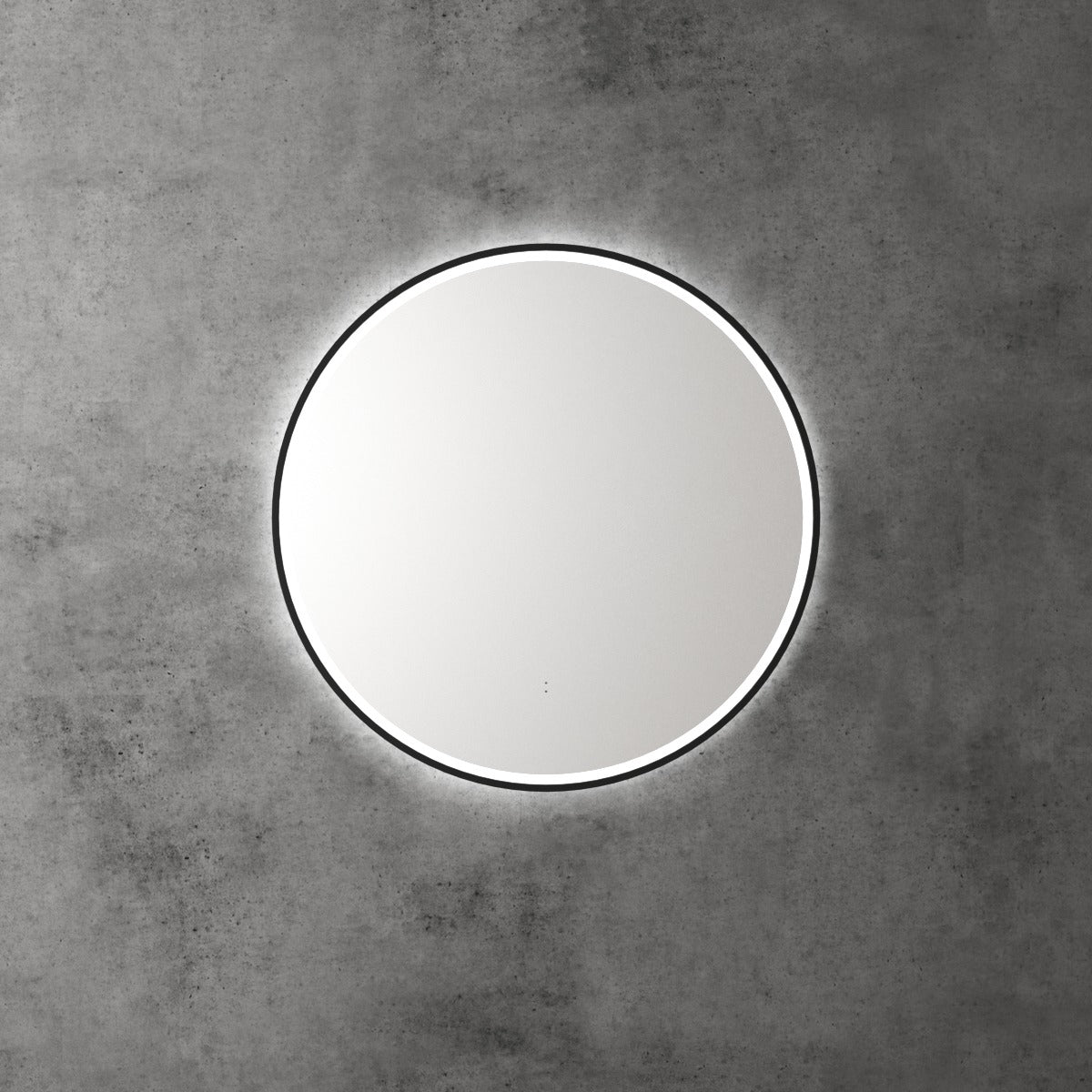 Aulic Windsor round LED mirror with black frame, front-lit and backlit glow, mounted on a concrete wall