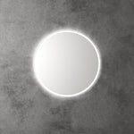 Aulic Windsor round LED mirror with backlit halo, mounted on a concrete wall, front view