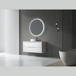 Aulic Windsor round LED mirror above a white vanity in a modern bathroom, with backlit glow and a frameless look