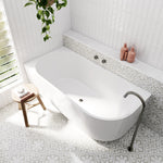 Bao Elegant white corner bath in a bright bathroom, shown with patterned tiling, wall niche and matte black tapware