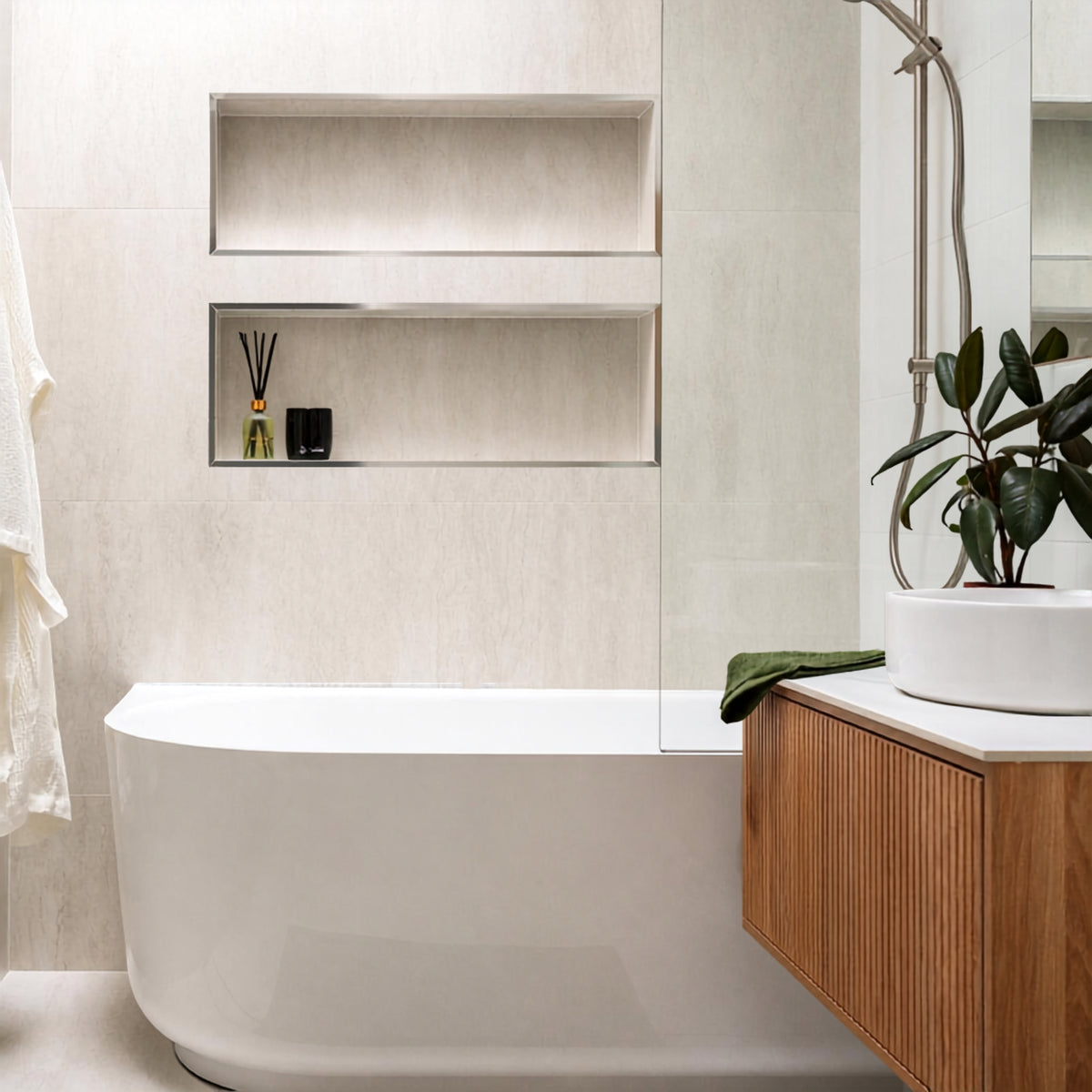 Bao Elegant white back-to-corner bath in a modern bathroom with wall niches and timber vanity