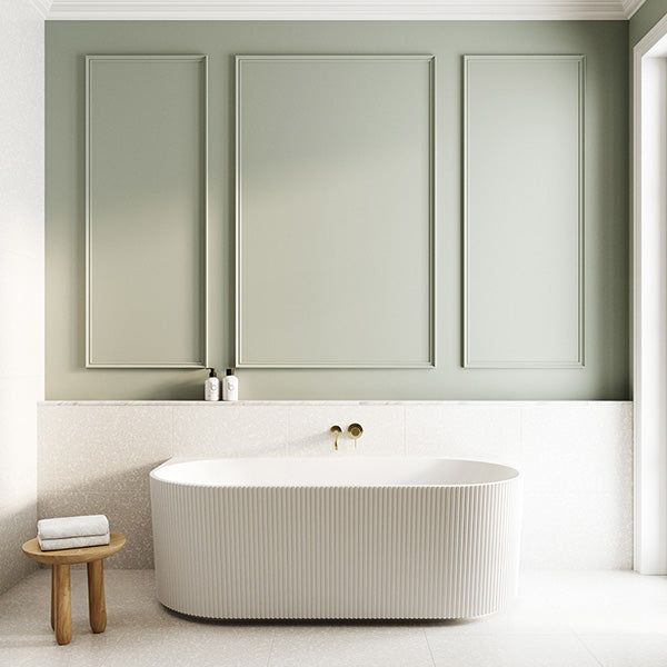 Bao Bath fluted back to wall bath in matte white, oval acrylic tub shown in a modern bathroom setting