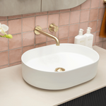 Bao Bath Pill 500mm matte white oval above counter ceramic basin with brass wall mixer on vanity