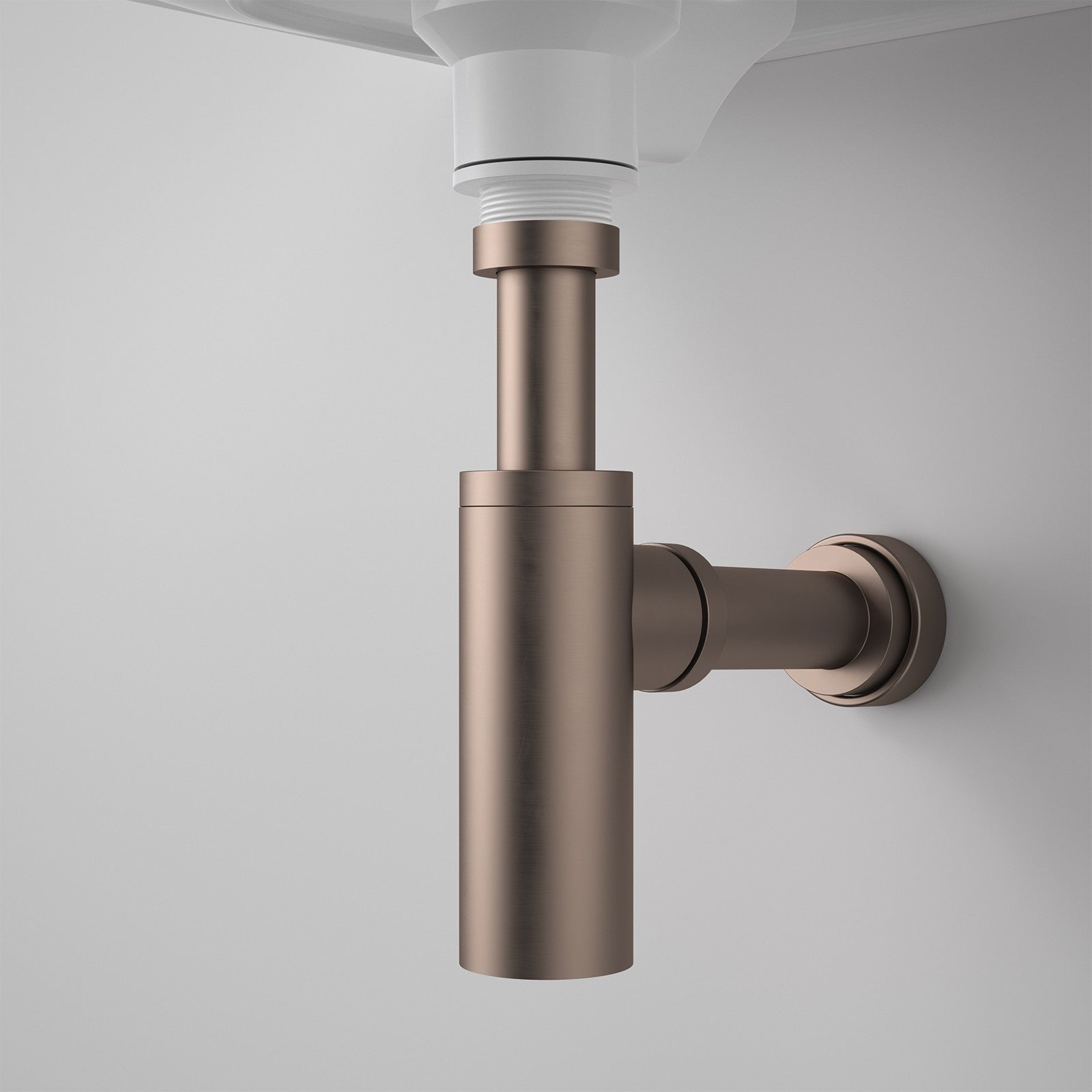 Caroma 40mm bottle trap in brushed bronze, shown installed under a wall-hung basin on a white wall