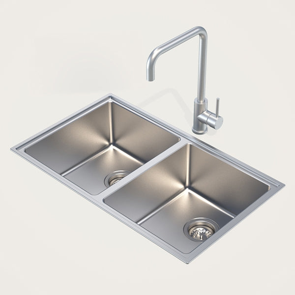 Caroma stainless steel double bowl kitchen sink with mixer tap, rectangular overmount/undermount style on a plain background