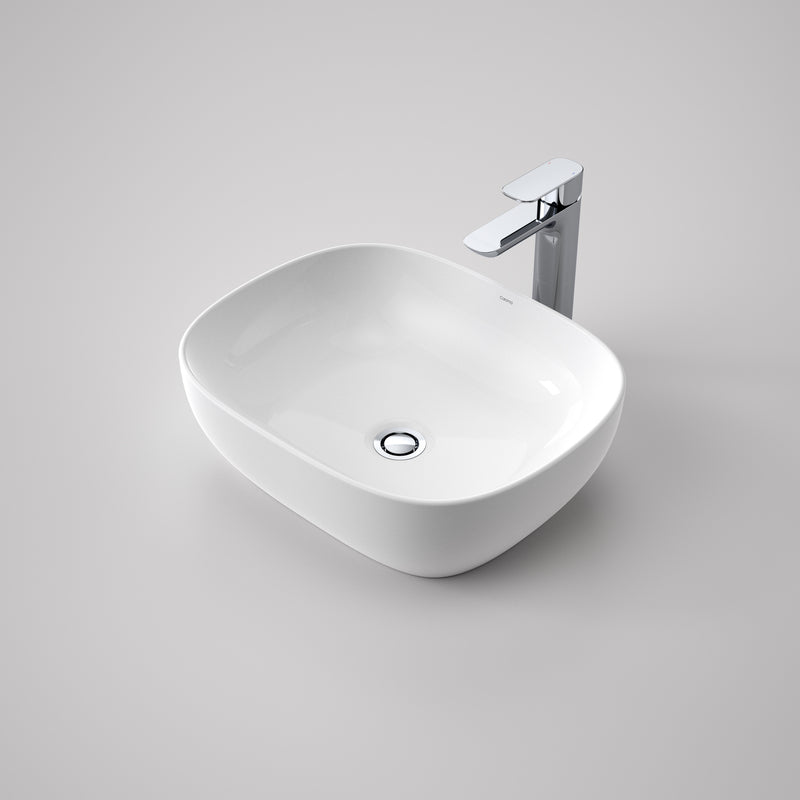 Caroma Artisan white glossy curved rectangle above counter basin with chrome waste and mixer tap, front view on grey background