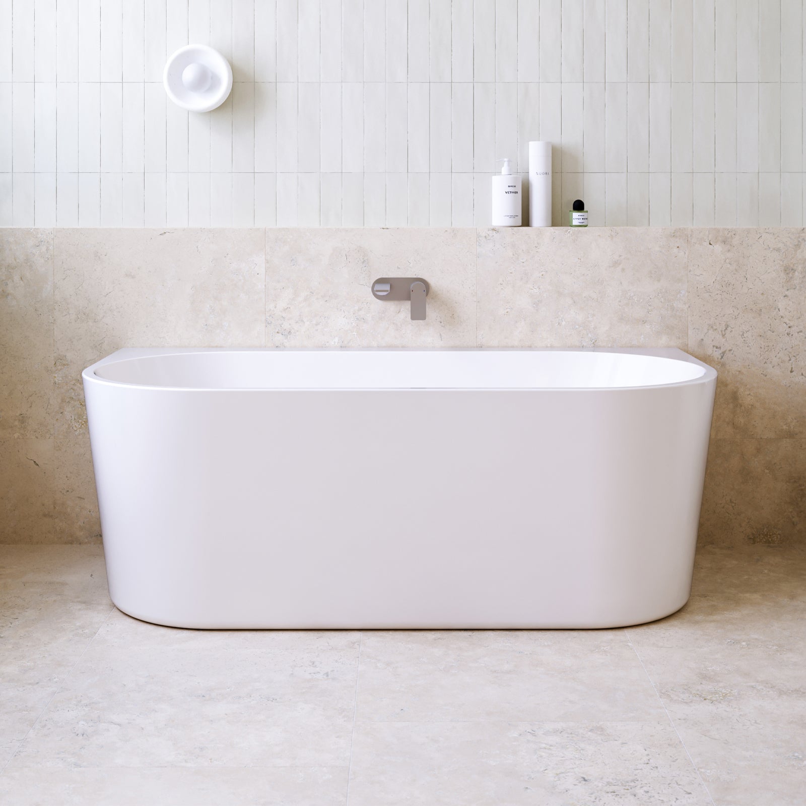 Caroma Urbane II white back to wall freestanding bath, front view in a tiled bathroom setting