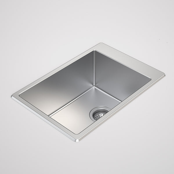 Caroma Urbane II stainless steel laundry tub, single bowl inset sink with basket waste, angled view.
