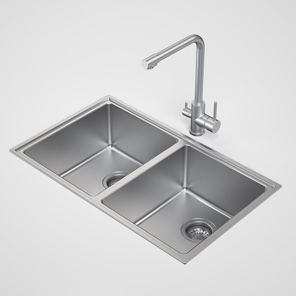 Caroma Urbane II stainless steel double bowl kitchen sink with tap, rectangular overmount style shown in a clean studio view