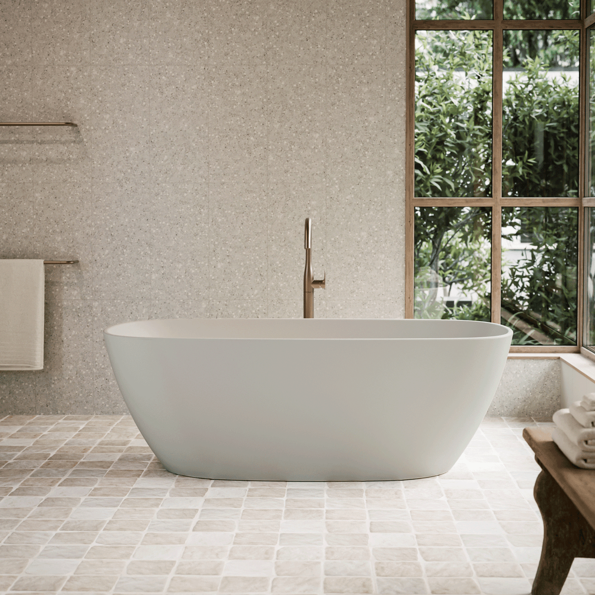 Caroma Contura II freestanding oval bath in matte clay, shown in a modern bathroom with window and floor tiles