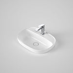 Caroma Contura II white ceramic oval inset basin with tap landing and single tap hole, angled view