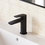 Caroma Contura II matte black basin mixer on a white vanity basin in a bathroom setting