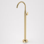 Caroma Contura II freestanding bath filler tap in brushed brass, floor mounted with curved spout and lever handle