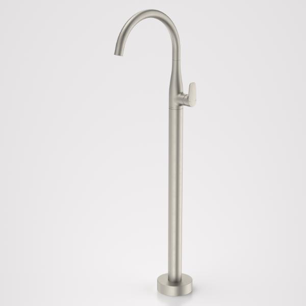 Caroma Contura II floor-mounted bath filler tap in brushed nickel, with tall curved spout on round base