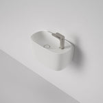 Caroma Contura II matte white wall basin with 1 tap hole, shown mounted on a wall with mixer tap