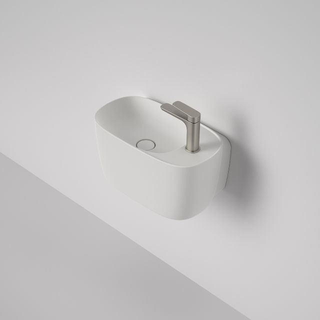 Caroma Contura II matte white wall basin with 1 tap hole, shown mounted on a wall with mixer tap