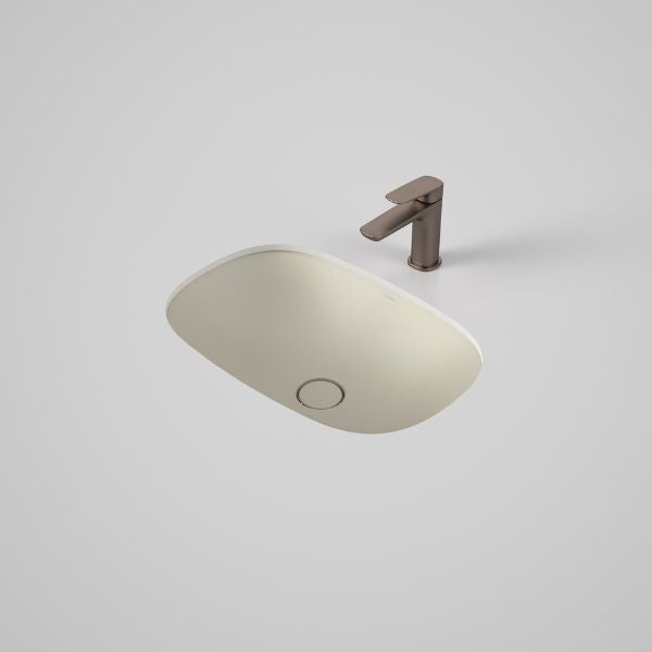 Caroma Contura II undercounter basin in matte clay, oval ceramic basin with tap above on a white benchtop.