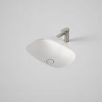 Caroma Contura II matte white undercounter basin, oval ceramic bathroom basin with flush-fitting waste shown in vanity top