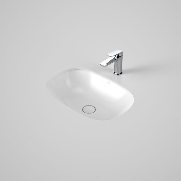 Caroma Contura II white ceramic undercounter oval basin with chrome mixer tap on a grey benchtop