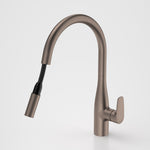Caroma Contura II pull out sink mixer in brushed bronze, with curved spout and retractable handpiece on white background