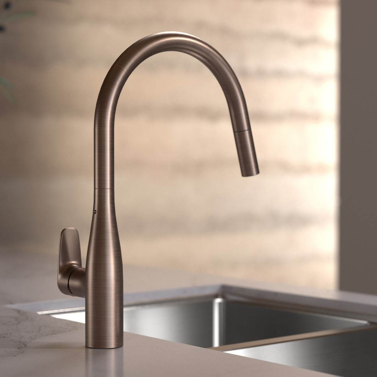 Caroma Contura II pull out sink mixer in brushed bronze, shown mounted above a kitchen sink with arched swivel spout