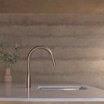 Caroma Contura II brushed bronze pull-out sink mixer on a kitchen benchtop with sink, side view