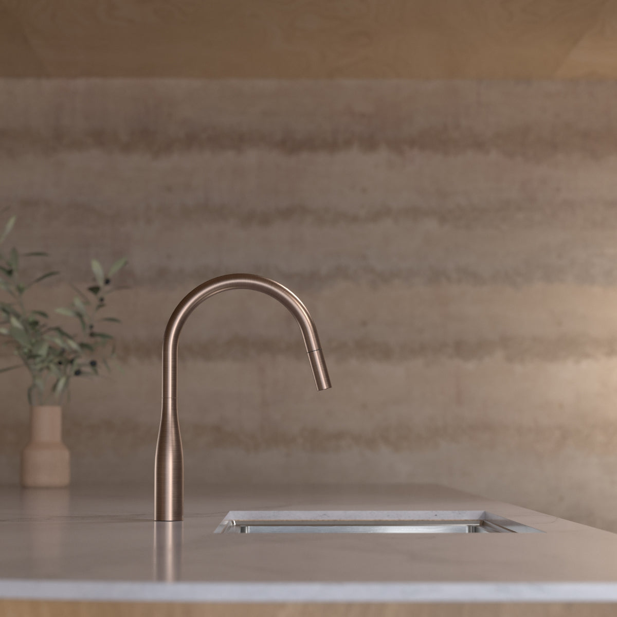 Caroma Contura II brushed bronze pull-out sink mixer on a kitchen benchtop with sink, side view