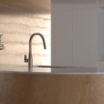 Caroma Contura II pull out sink mixer in brushed bronze, hob mounted over a kitchen sink.