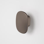 Caroma Contura II small robe hook in brushed bronze, oval wall-mounted bathroom accessory on a light background