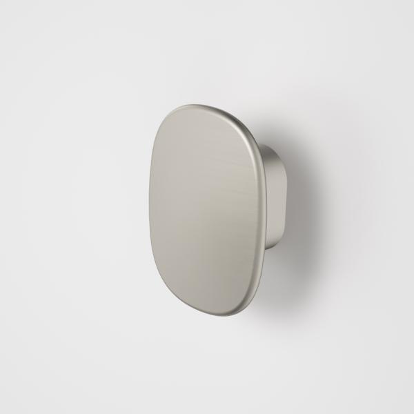 Caroma Contura II small robe hook in brushed nickel, oval wall-mounted bathroom accessory on white background