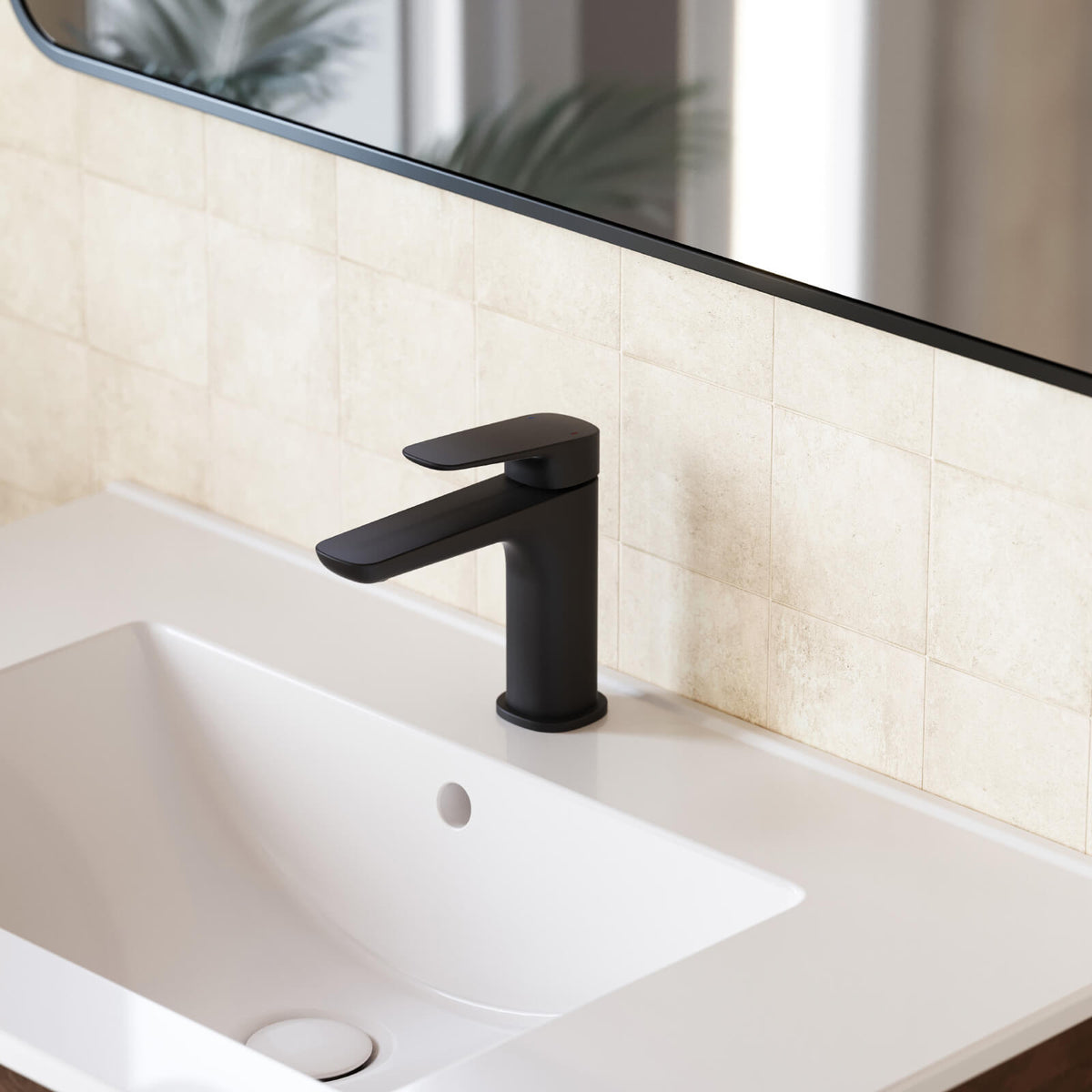 Caroma Contura II matte black basin mixer, hob mounted over a white basin in a modern bathroom setting
