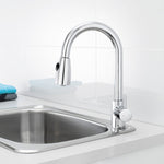 Caroma Husk chrome pull out sink mixer with swivel gooseneck over a stainless steel kitchen sink and white benchtop