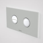 Caroma Invisi Series II round dual flush metal flush plate and buttons in light grey, wall-mounted