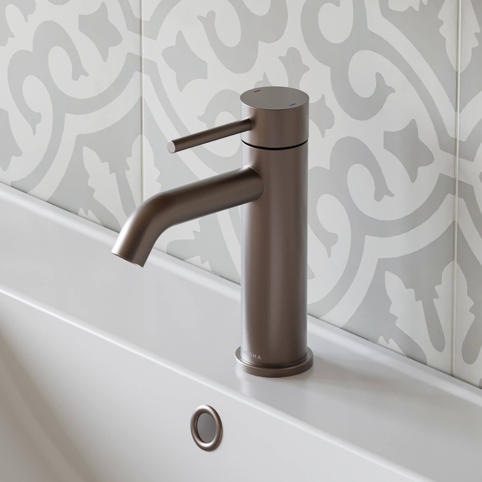 Caroma Liano II basin mixer in brushed bronze, shown hob mounted above a white basin