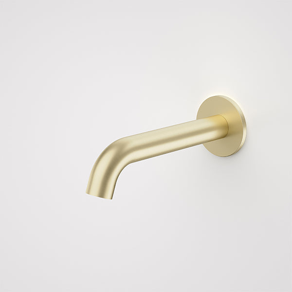 Caroma Liano II wall-mounted basin/bath outlet in brushed brass, shown in side view with round wall plate and curved spout