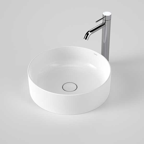 Caroma Liano II round white above counter basin with tap and waste, front view on grey background
